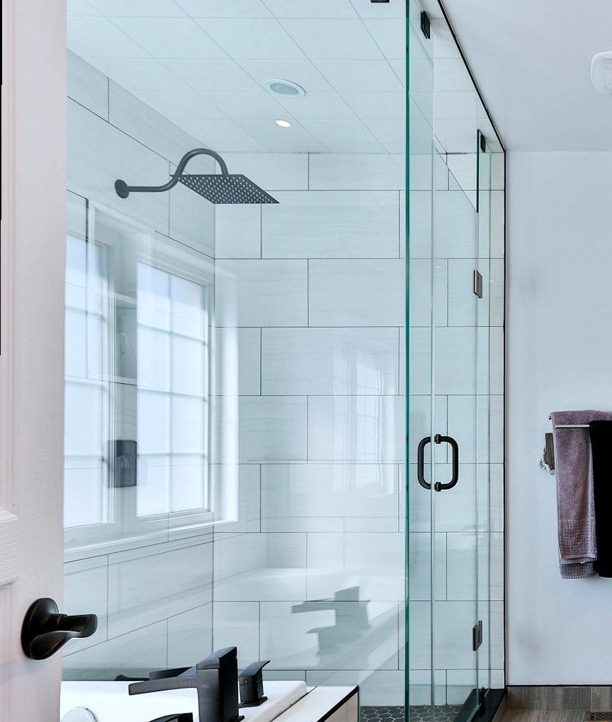 White tiled shower enclosure with large-format wall tiles
