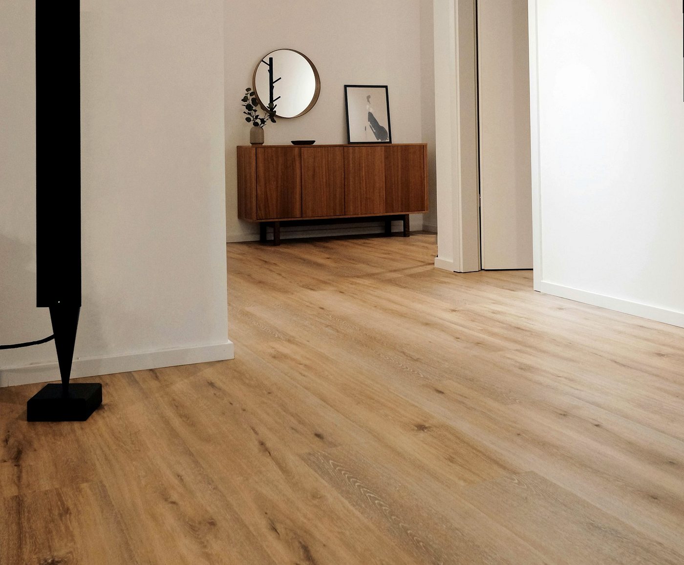 Newly laid wood-effect flooring running through a hallway