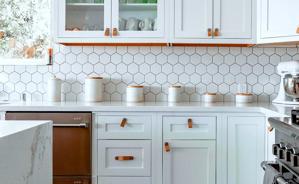 White hexagonal tiles fitted as a kitchen splashback